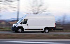 A FedEx truck speeding down the highway.