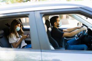 A Lyft driver transporting a passenger, who is on her phone. What should you do if you’re in an accident with a Lyft?